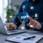 ERP consultant reviewing business operations on a laptop with a digital ERP software interface